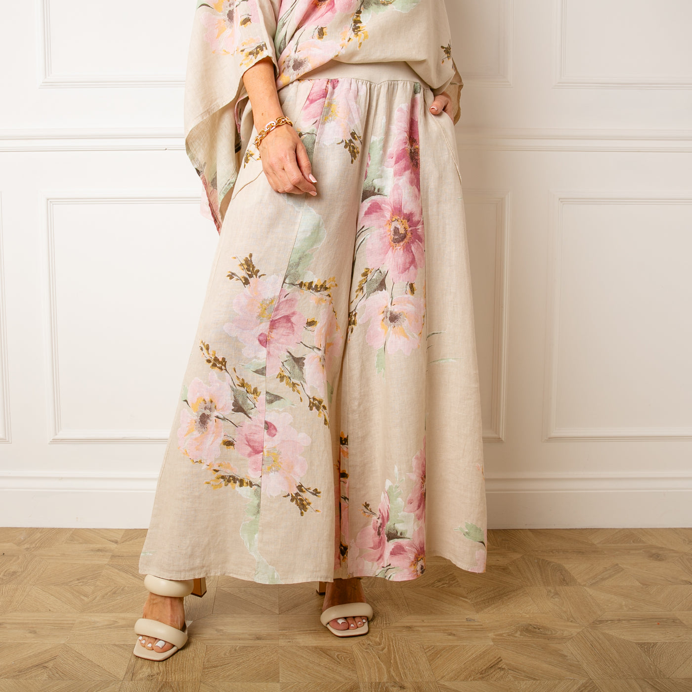 The stone cream Bouquet Print Linen Trousers with a wide stretchy elasticated waistband for extra comfort 