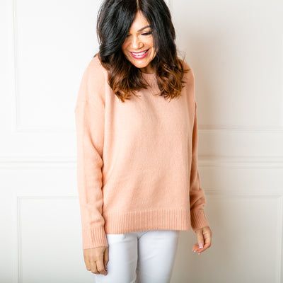 The Essentials Knitted Jumper in peach with ribbing detail around the neckline, cuffs and bottom hemline